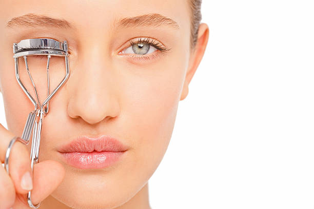istock Young woman applying eyelash curler 174673068