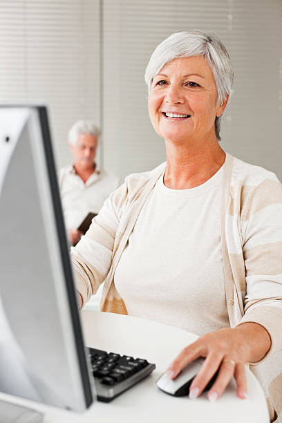 istock Mature lady working on the computer at home 174673103