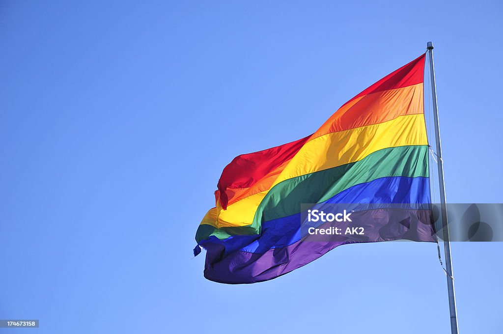 Rainbow flag Rainbow flag over blue sky. Rainbow Flag Stock Photo