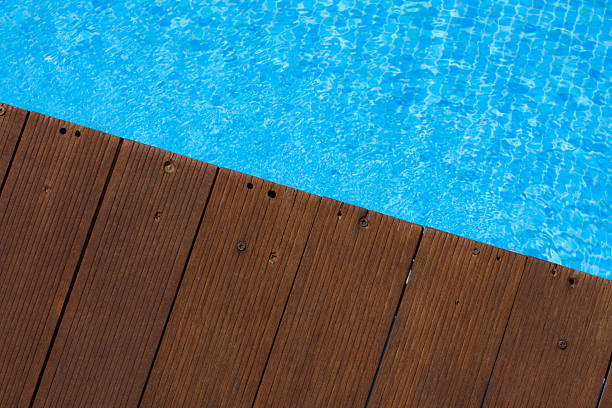 istock Wooden Pool Deck and Blue Water 174673518