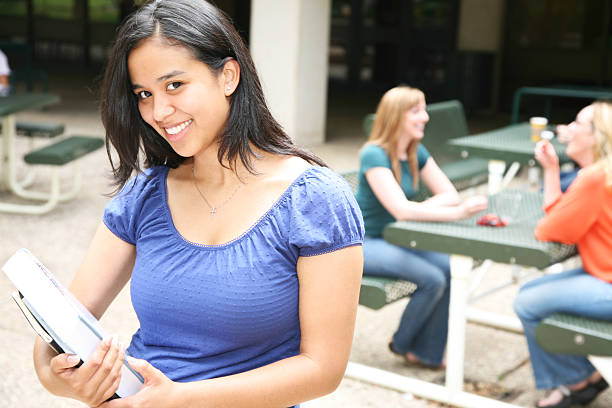 istock Smiling Hispanic College Girl Holding Books Before Class 174673640