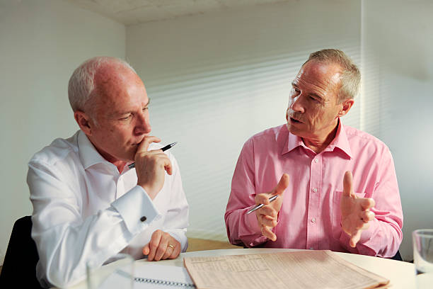 istock senior business men in meeting 174673666
