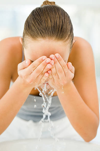 istock Young woman cleaning her face 174674444