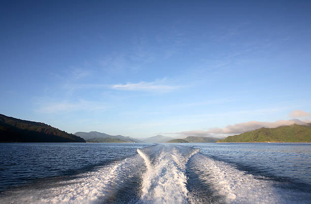 Boat wake and blue sky stock photo