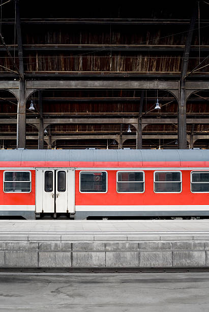 istock Red suburb train at the platform - wooden station roof 174675272
