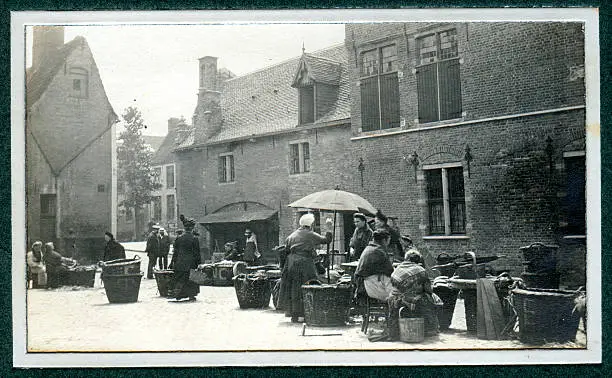 "Vintage photograph showing Edwardian people at a market, possibly either Knokke or Bruges, Belgium pre world war one."