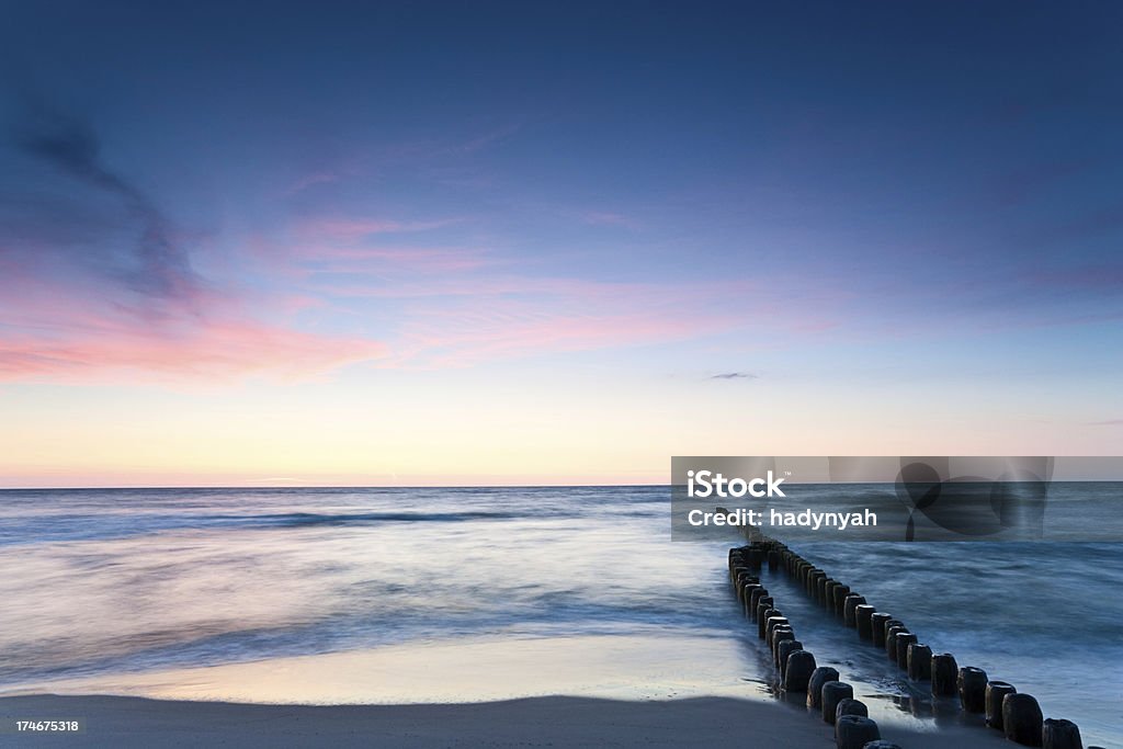 Sunset over the sea Sunset over the Baltic Sea - waves crashing against the breakwater. http://bem.2be.pl/IS/sand_dunes_380.jpg Bay of Water Stock Photo