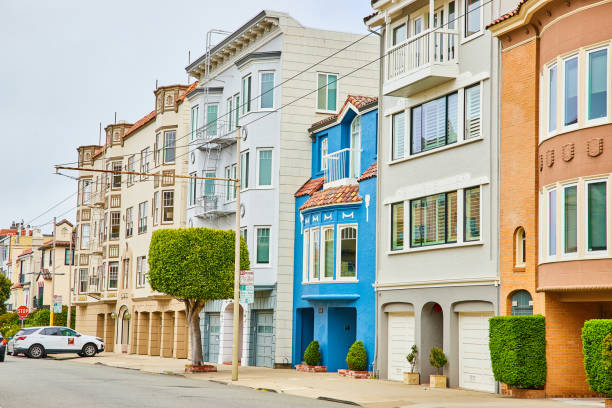 istock Squat blue house with MMMM above windows between closely compact row of houses 1746753989