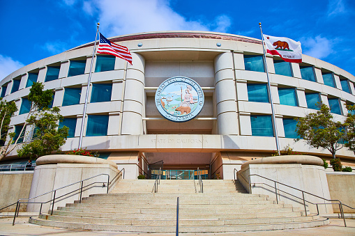 Image of State of California Public Utilities Commission building framed by American and California flags