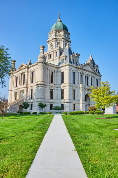istock Straight sidewalk path leading to castle like courthouse building on bright summer day 1746755261
