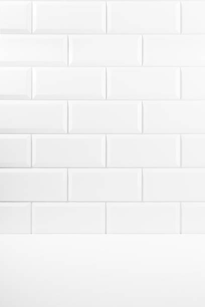 istock Abstract interior with white ceramic rectangle tiles on wall and wood floor or shelf, mockup, empty. Template for presentation, showing, design in soft light minimalistic style. 1746755778