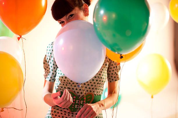 istock woman behind balloons 174675590