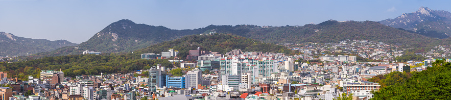 Green mountains overlooking the crowded cityscape of central Seoul, South Korea’s vibrant capital city.