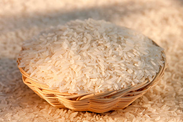 Thai Jasmine White Rice in a basket. Thai Jasmine White Rice in a basket. Selective focus.  jasmine rice stock pictures, royalty-free photos & images