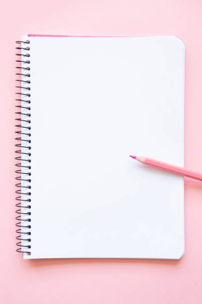 istock pink pencil on notepad with blank page on pink background 1746763302