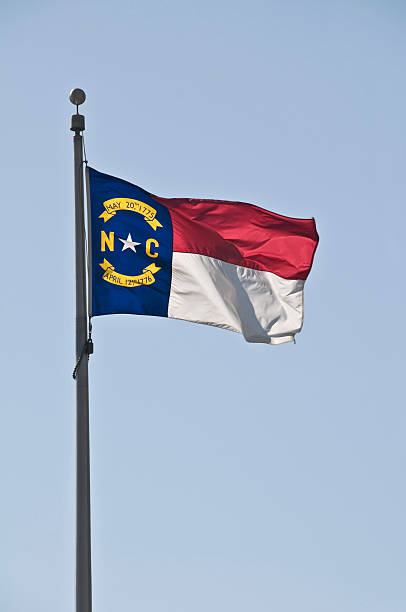 istock The North Carolina flag waving on a pole 174676367