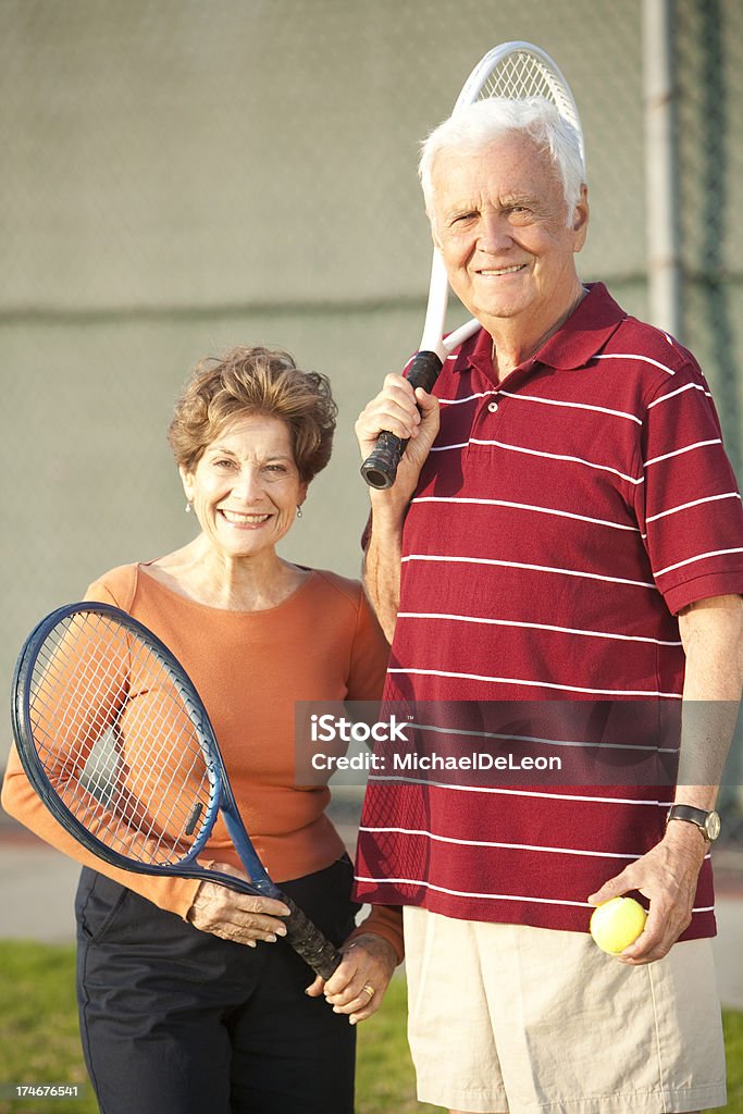 Senior Tennis Couple Senior tennis couple smile to camera.View More: 60-64 Years Stock Photo