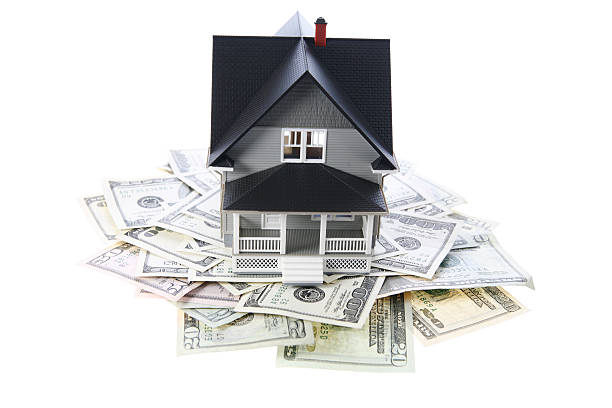 istock House on pile of cash 174676573