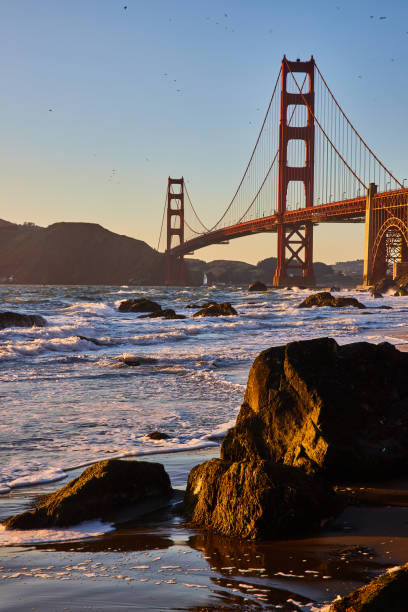 istock Wet sandy beach with giant boulders and distant Golden Gate Bridge at sunset 1746770202