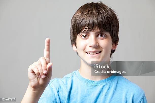 Boy Holds Up One Finger Stock Photo - Download Image Now - Child, Number 1, Number One Finger Sign