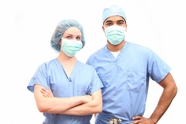 Surgeons in scrubs and face masks stock photo