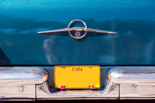 Blank yellow Cuban vehicle licence plate on old American car