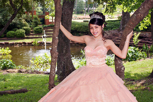 Beautiful Quinceanera Young teen wearing a quinceanera dress on her 15th birthday quinceanera stock pictures, royalty-free photos & images