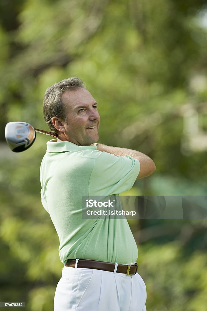 Golfer Golfer playing a shot, waist up 30-34 Years Stock Photo