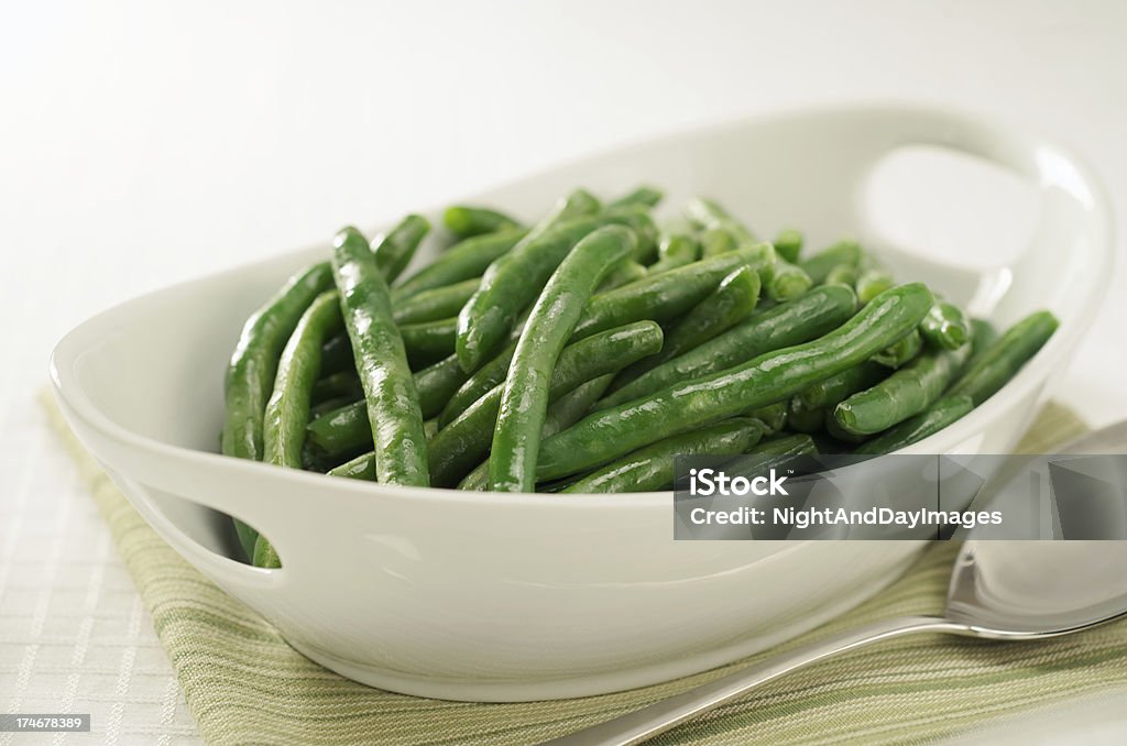 Healthy Steamed Green Beans in White Serving Bowl Freshly steamed green beans ready to be served. Green Bean Stock Photo