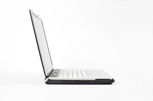 Left side view of open laptop on white background. Copy space.