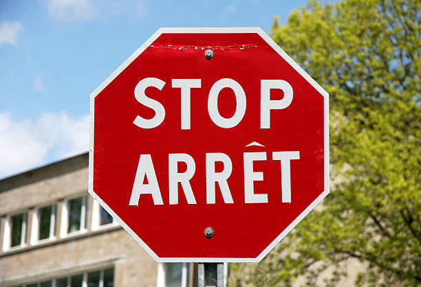 bilingue panneau stop - stop mot anglais photos et images de collection
