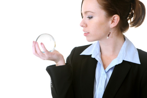 Business woman gazing into crystal ball.