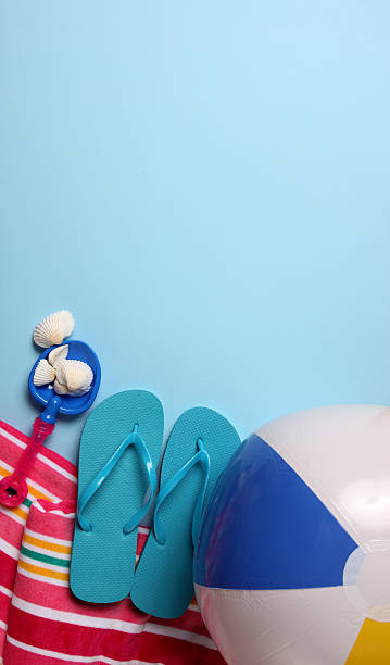 istock Beach ball flip flop and towel 174679370