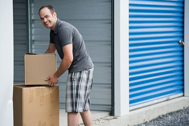 Man with Boxes Outside Self Storage Unit Lifestyle stock photo