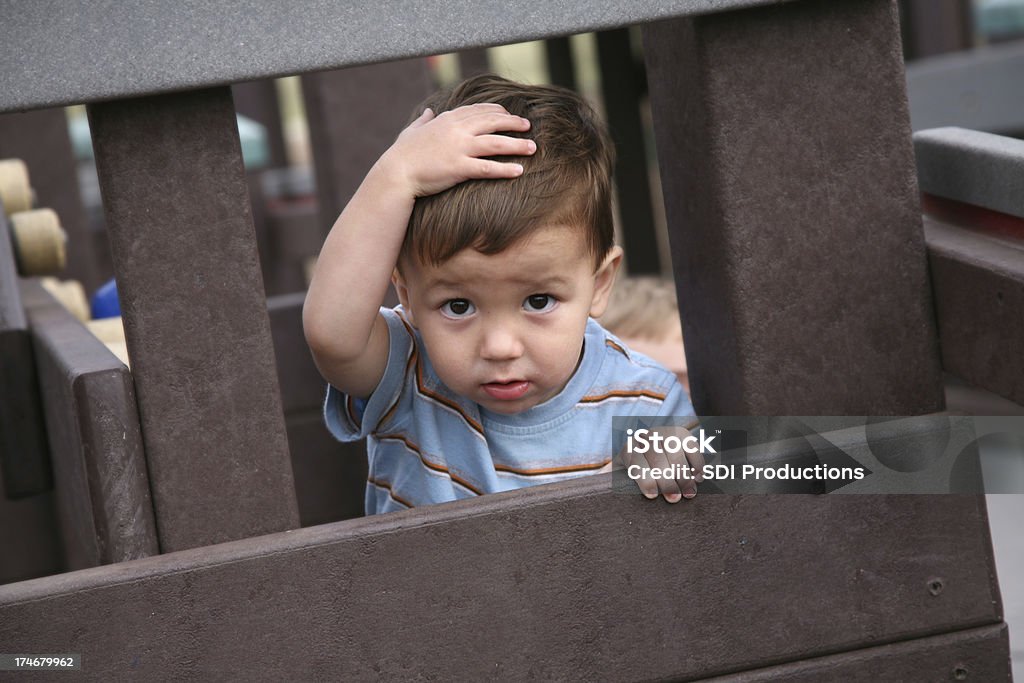 Happy Boy Looking Through at Playground Happy Boy Looking Through at a Playground. Colliding Stock Photo
