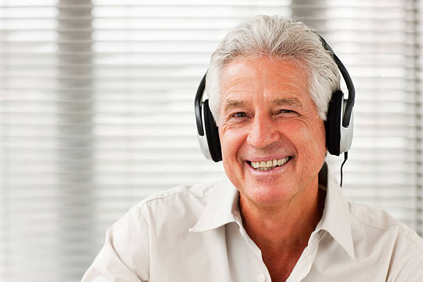 istock Smiling senior man listening to music 174680086