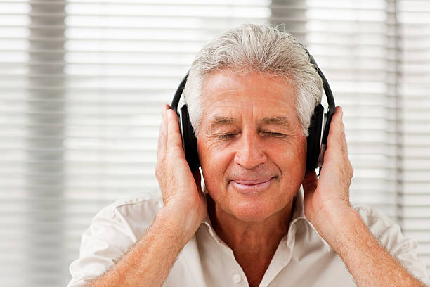 istock Senior man listening to music 174680087