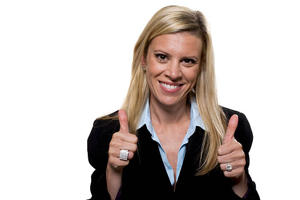 Attractive businesswomen giving two thumbs up stock photo