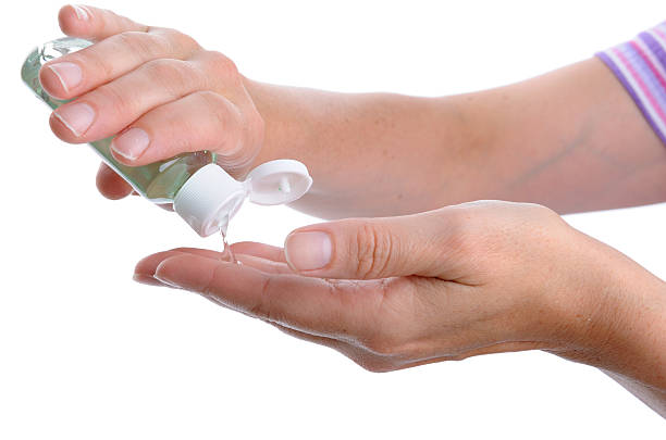istock Woman Washing Hands with Alcohol Sanitizer 174680511