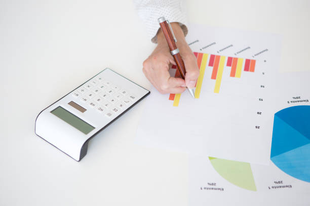 istock Hands of a woman working with financial statistics documents. 1746811066