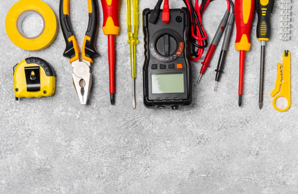 istock Electrician tools on light background.Multimeter,construction tape,electrical tape, screwdrivers,pliers,an automatic insulation stripper, socket and LED lamp.Flatley.electrician concept. 1746822395