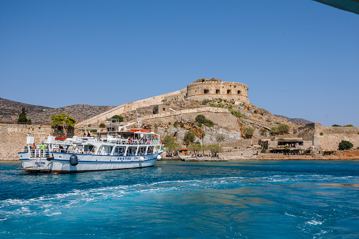 Spinalonga, Greece - September 3rd 2023:The motor yachts with tourists are near Spinalonga island