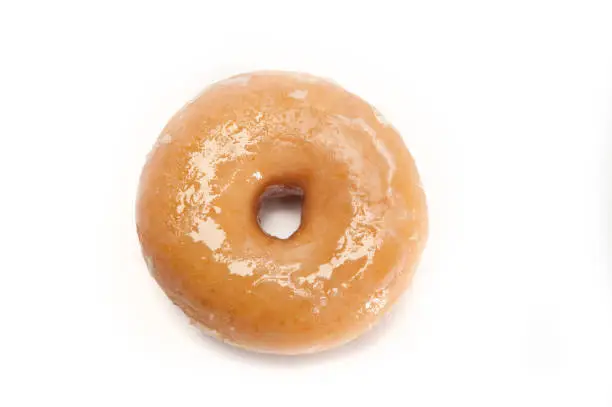 A single glazed doughnut isolated on white viewed from above