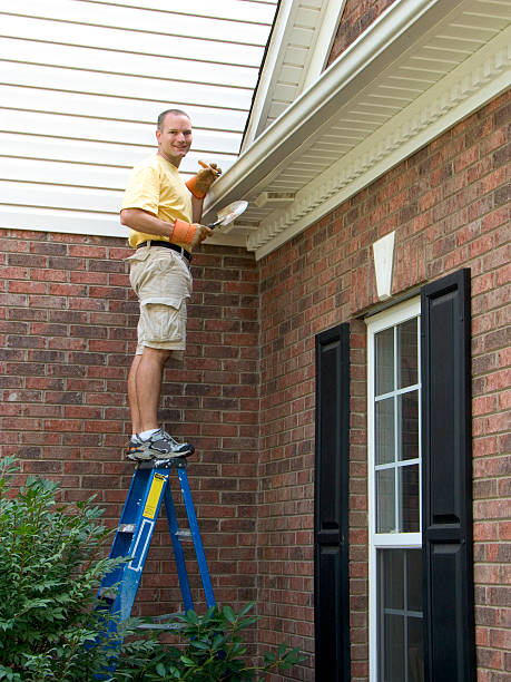 istock Homeowner Maintenance, Gutter Cleaning Looking. Dangerously Standing On Ladder. 174682891