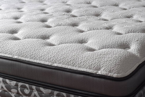 istock Part of a new white quilted soft mattress 1746831256
