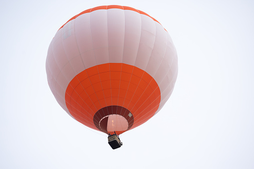 Colorful hot air balloon ascending into blue sky