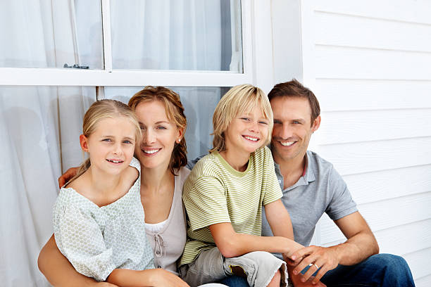 istock Happy family sitting in front of a window 174683524