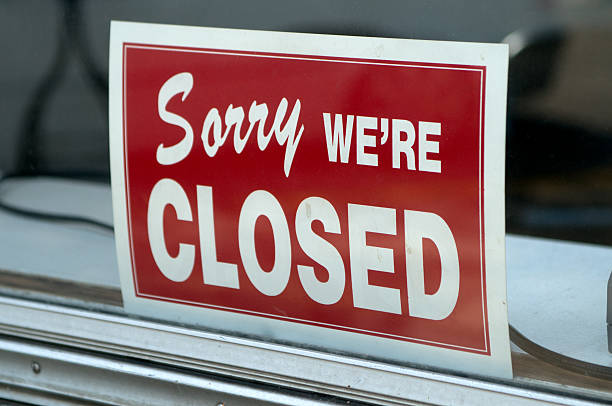 Red sign in window stating Sorry we're closed