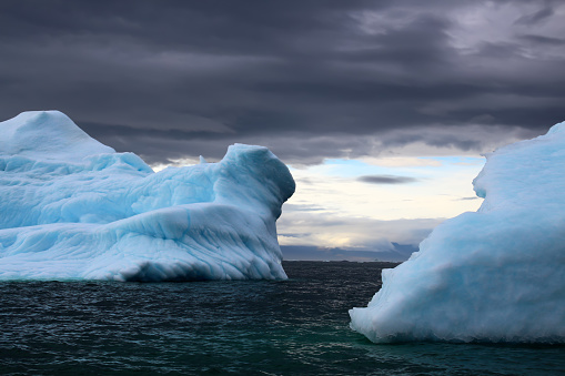 istock Close-up of an iceberg in Ilulissat Icefjord with dramatic sky in Disko Bay, Greenland, Denmark 1746839509