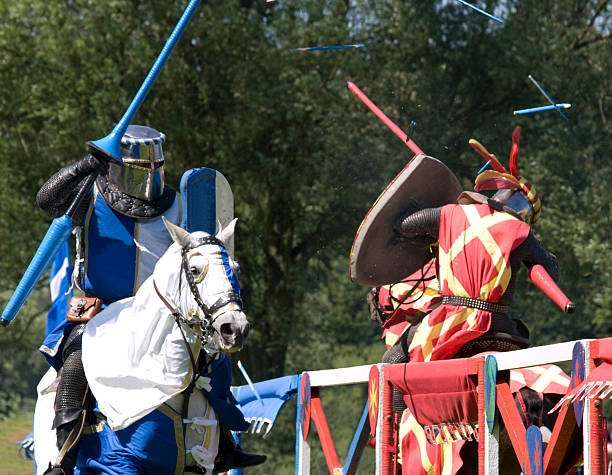 Knights clash at a Joust "Two riders at a re-enactment of a medieval jousting tournament clash on the fieldFor more, see my" reenactment stock pictures, royalty-free photos & images